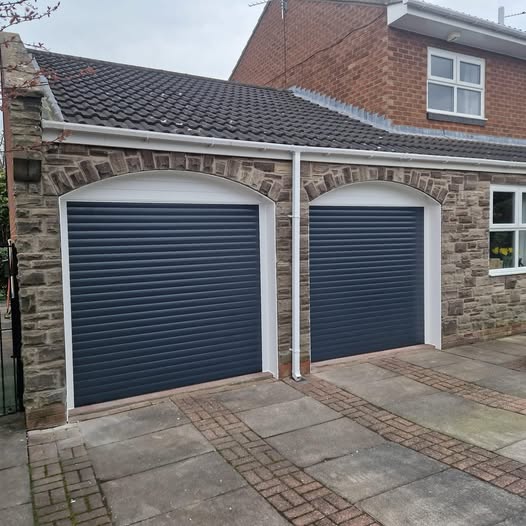 Anthracite grey insulated roller garage door fitted to a modern detached home